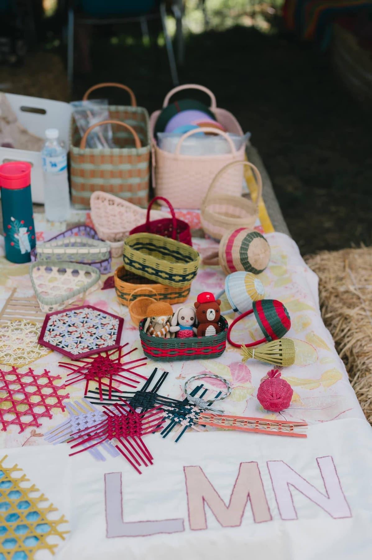 Small woven baskets and craft pieces laid out on a table at a workshop