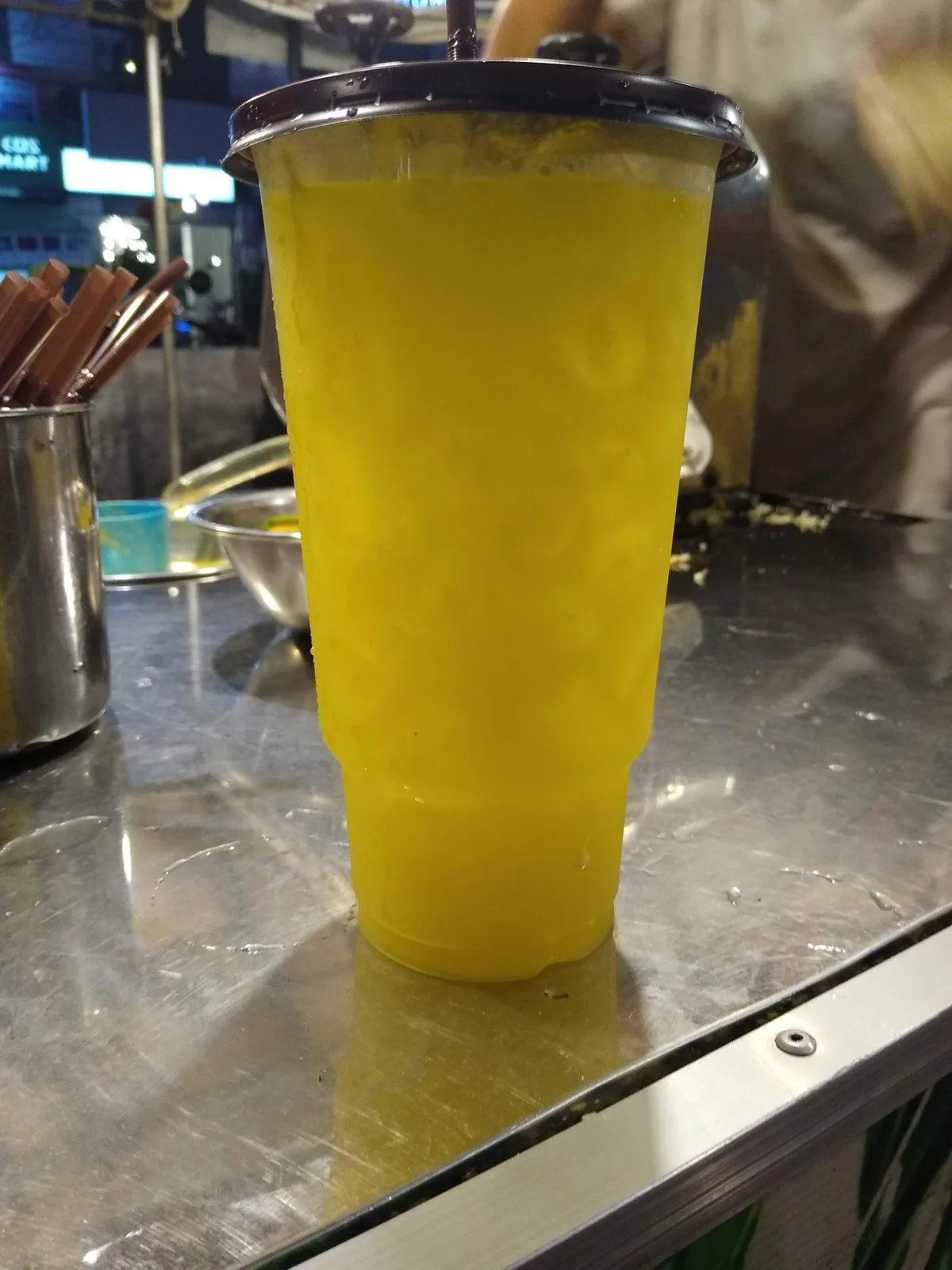 A tall cup of fresh sugar cane juice