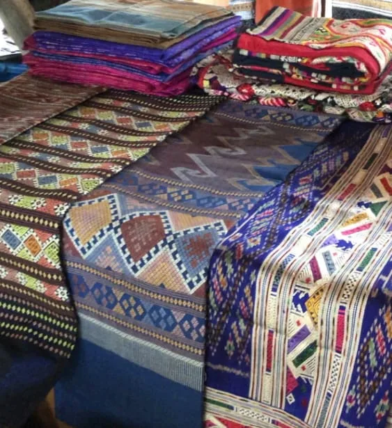 Folded woven textiles with diamond patterns at the Hoen Kham Dee stall