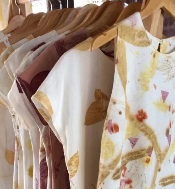 Botanical eco-print dresses hanging at the Walking Artisan stall