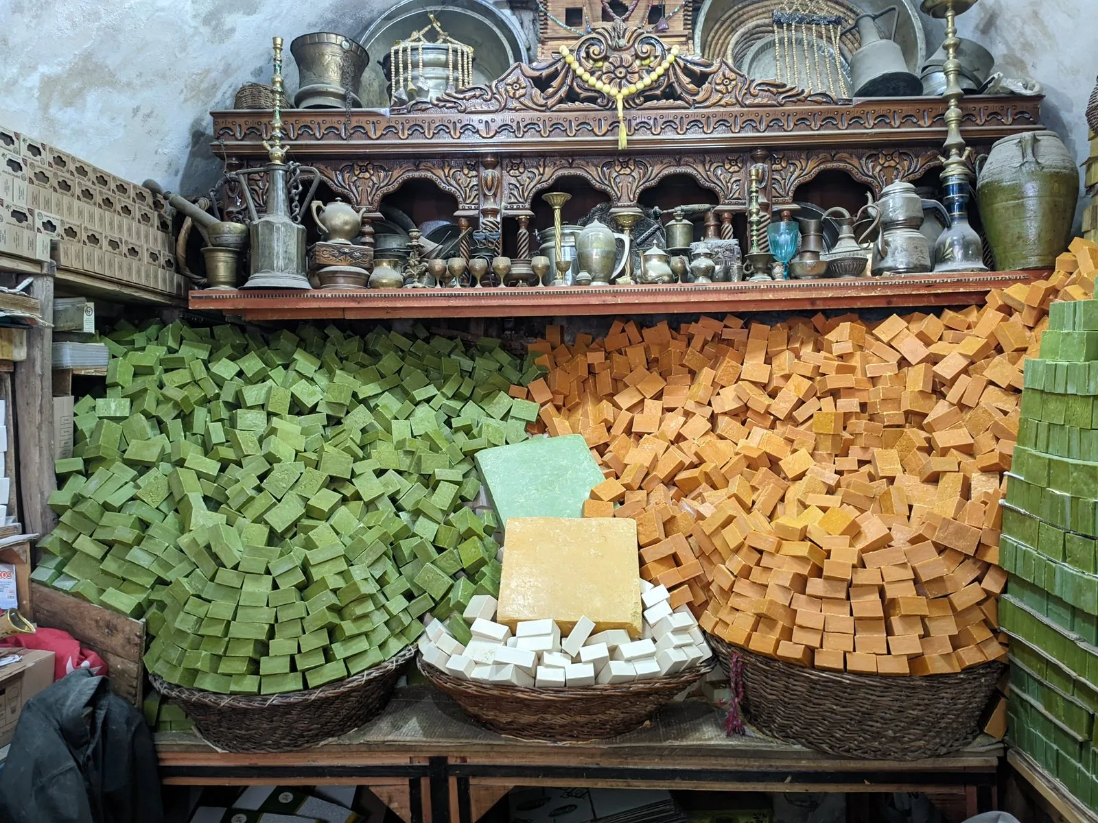 Piles of handmade soap bars in woven baskets